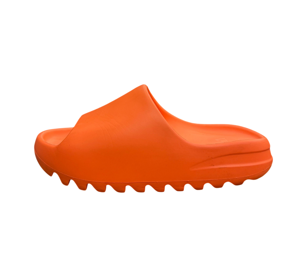 Genesis Boutique Yeezy Slide Enflame Orange in bright orange foam with a serrated outsole, side view on a shoe box.