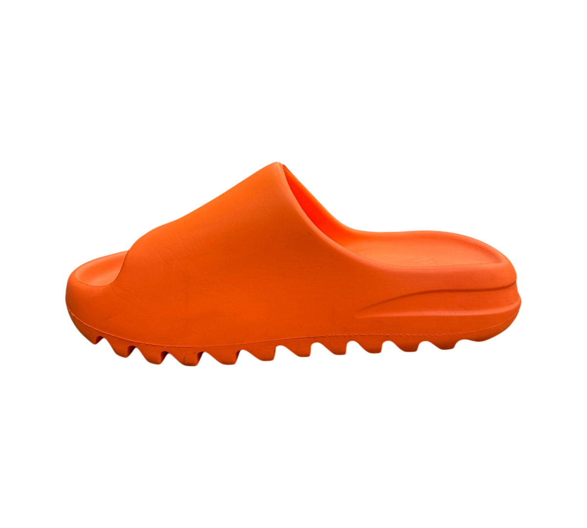 Genesis Boutique Yeezy Slide Enflame Orange featuring a vibrant orange foam construction and serrated outsole