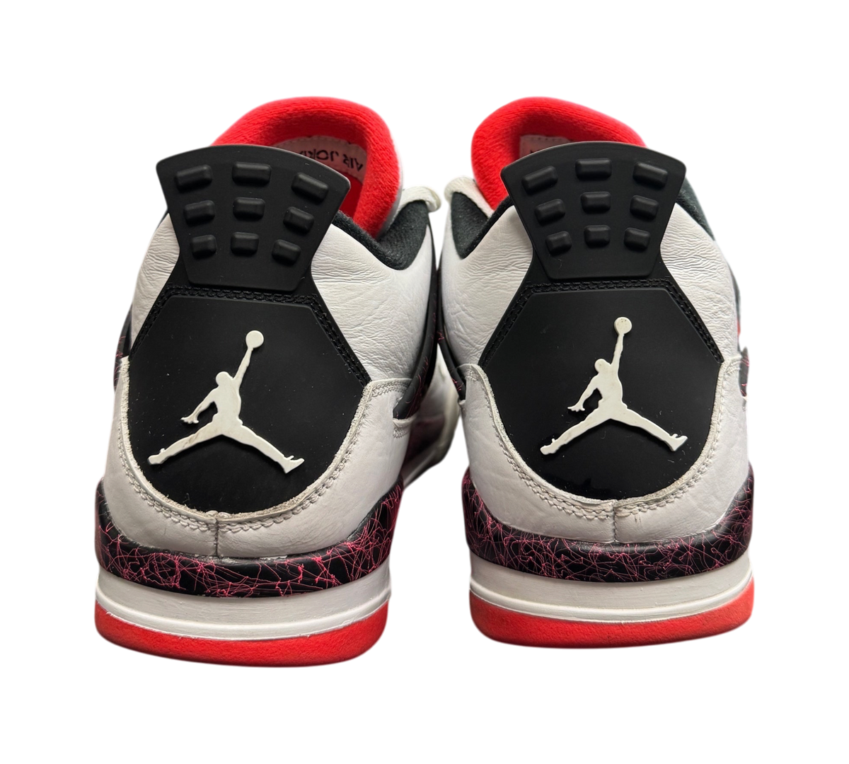 Genesis Boutique Jordan 4 Pale Citron sneakers showing the white leather heels with black and red patterned accents