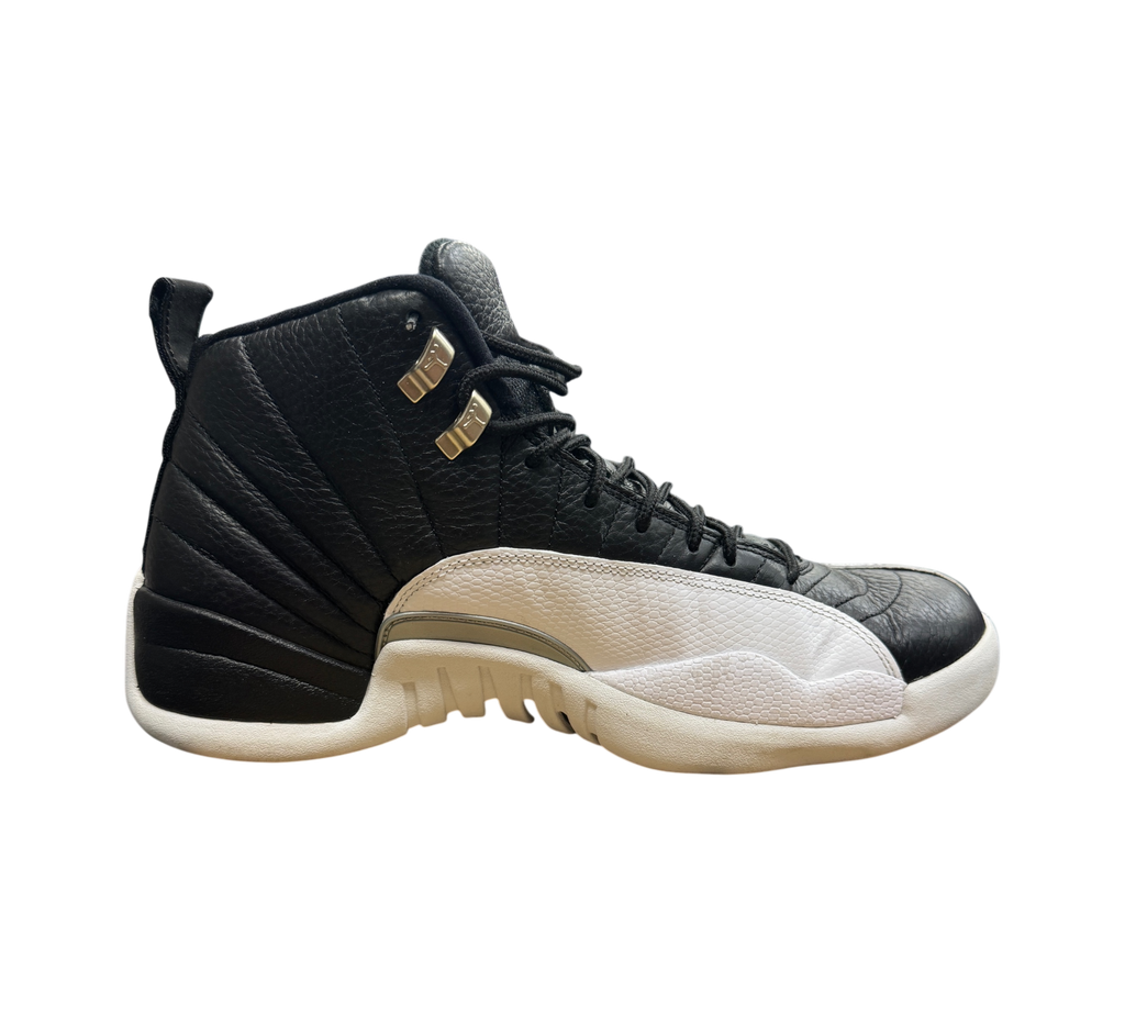 Genesis Boutique Jordan 12 Playoff sneakers in black and white leather with metallic silver eyelets on a shoe box