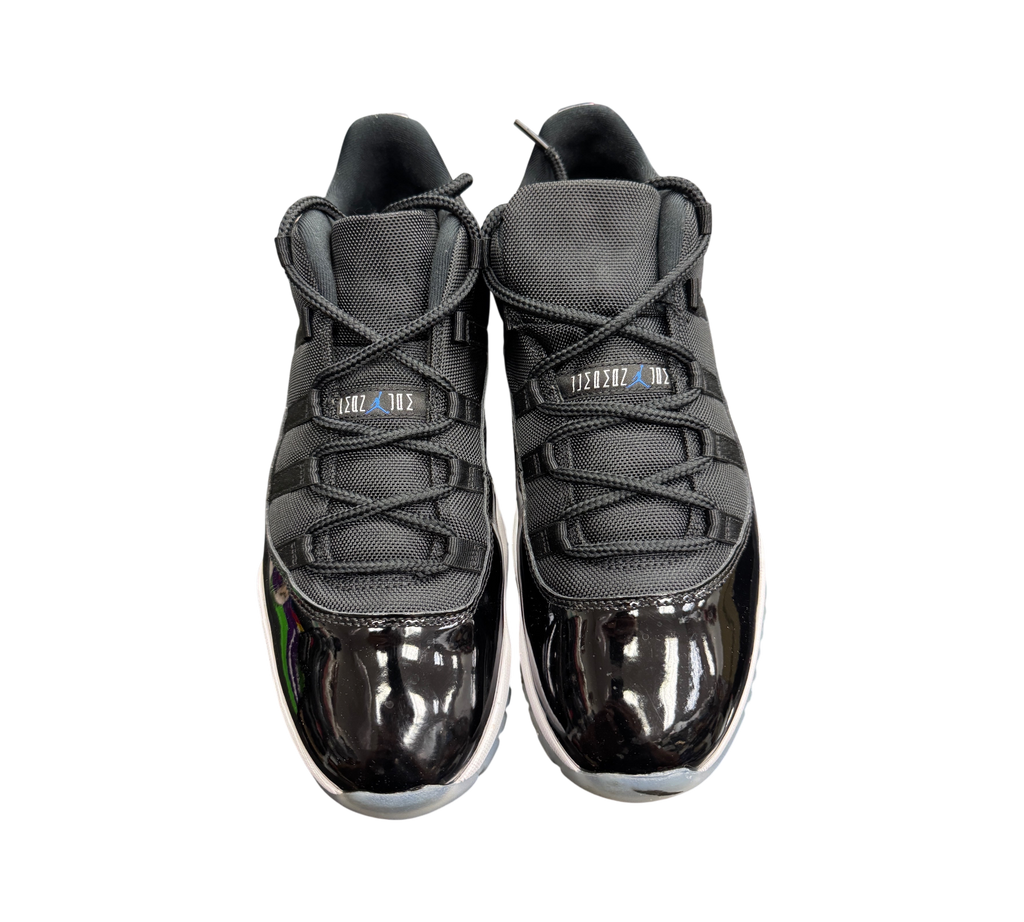 Genesis Boutique Jordan 11 Low Space Jam sneakers featuring black mesh uppers and glossy patent leather mudguards.