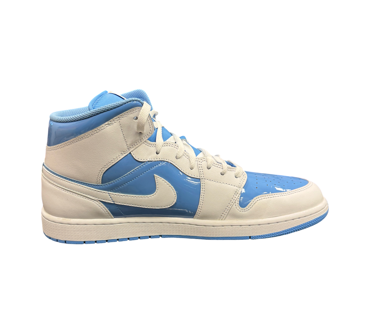 Genesis Boutique Air Jordan 1 Mid SE Legend Blue sneakers in white and patent light blue leather, side profile view.