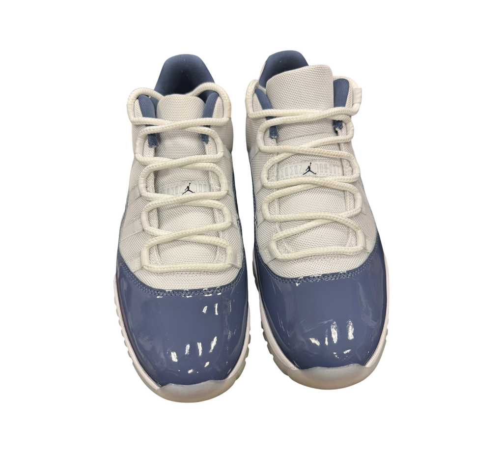 Genesis Boutique Air Jordan 11 Low Diffused Blue sneakers featuring white mesh uppers and glossy blue patent leather