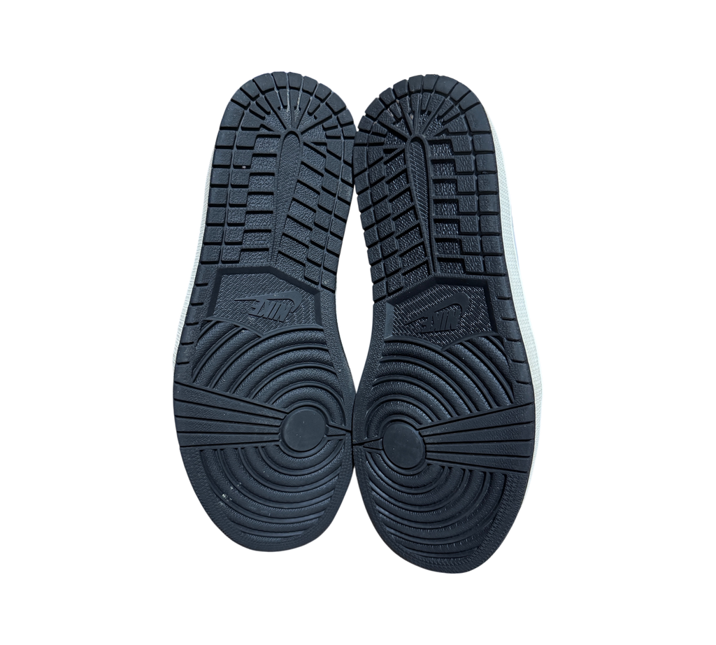 Genesis Boutique Jordan 1 High Visionaire sneakers showing the black rubber outsoles with classic traction pattern