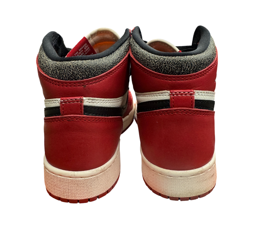 Genesis Boutique Jordan 1 GS Lost and Found high-top sneakers in red, white, and black, rear view on shoebox