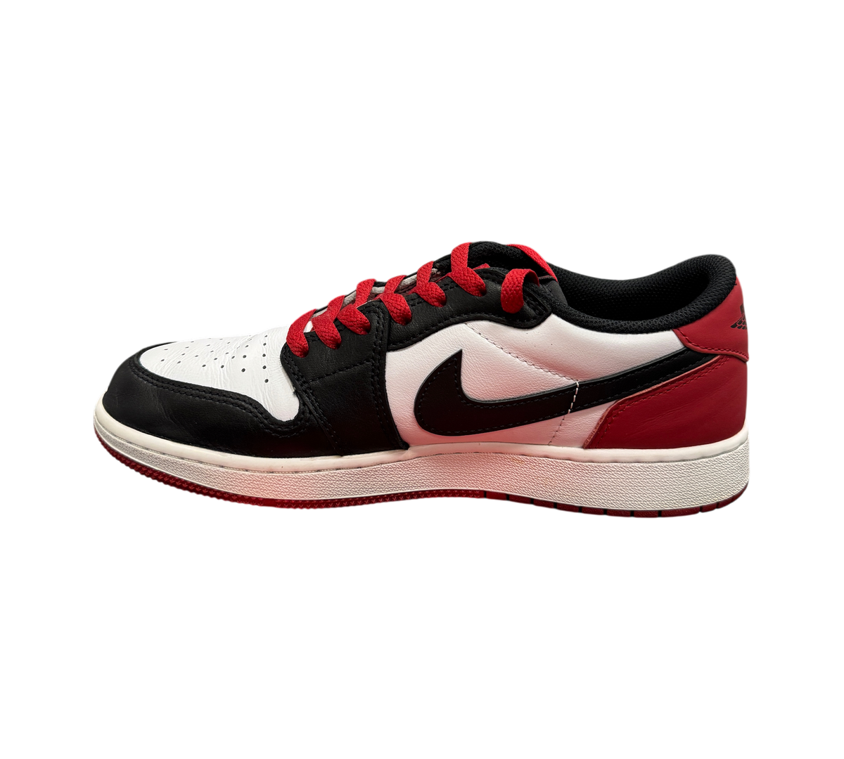 Genesis Boutique Jordan 1 Low Black Toe sneakers featuring white, black, and red leather panels with red laces.