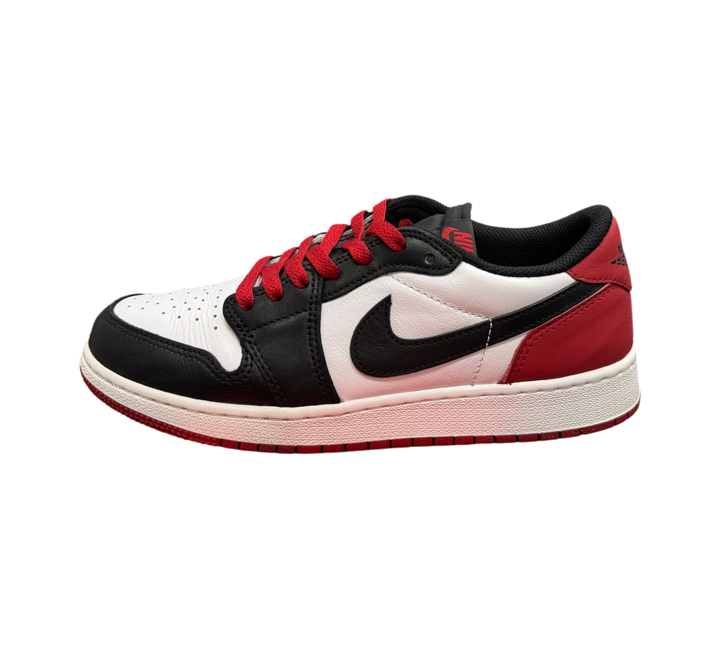 Genesis Boutique Jordan 1 Low Black Toe sneakers featuring white leather, black overlays, and red accents.