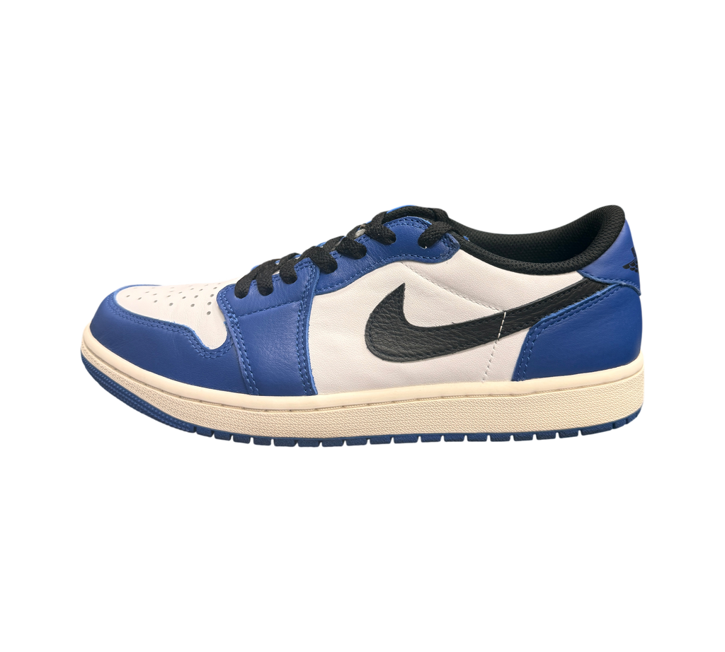 Genesis Boutique Jordan 1 Low Game Royal sneakers with white leather and blue overlays, black swoosh and laces.