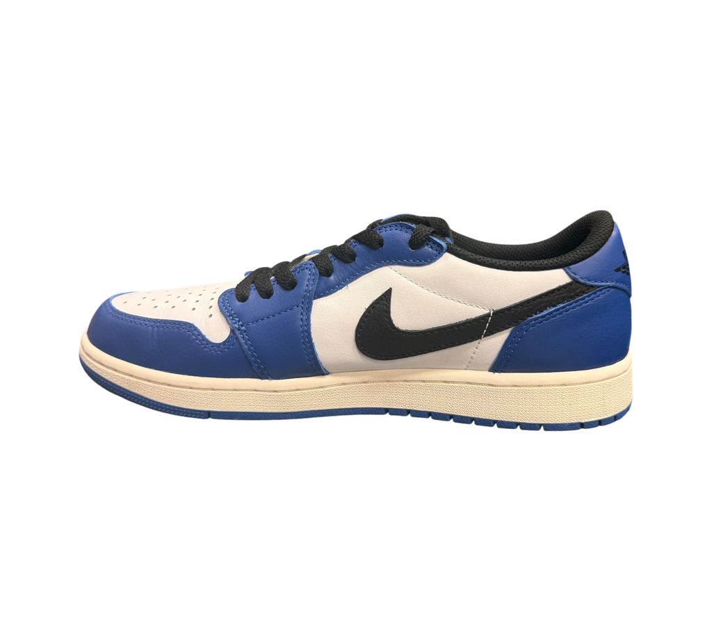 Genesis Boutique Jordan 1 Low Game Royal sneakers with white leather and royal blue overlays, black swoosh.
