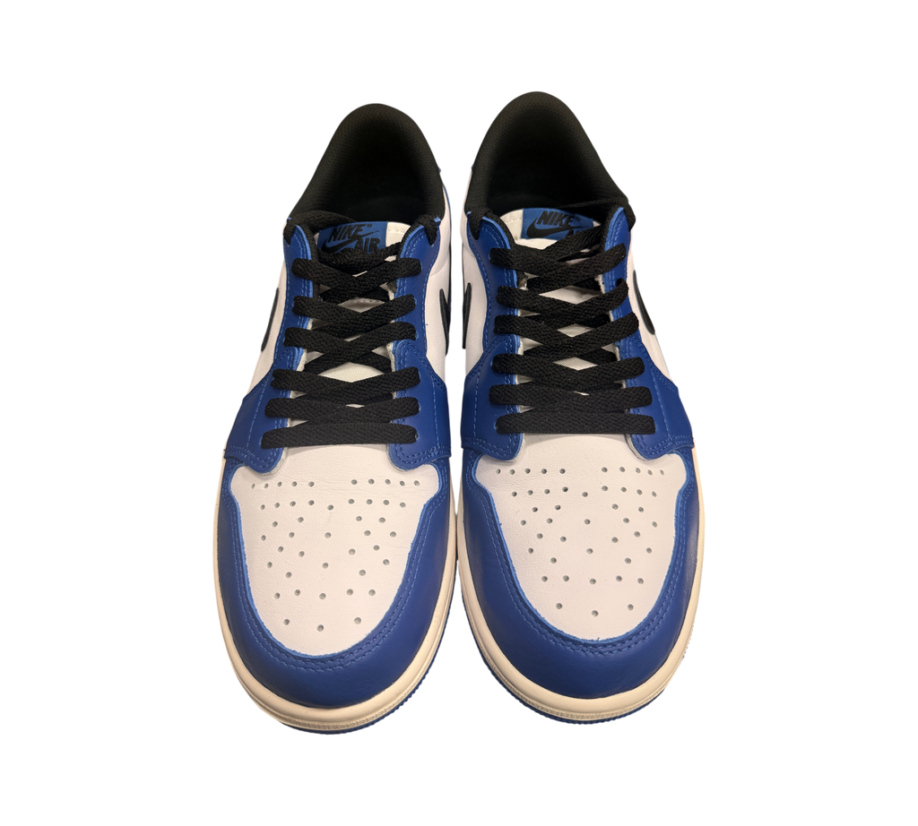 Genesis Boutique Jordan 1 Low Game Royal sneakers with white leather, blue overlays, and black laces.