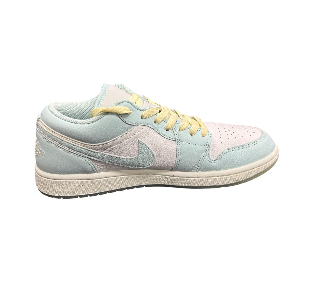 Genesis Boutique Jordan 1 Low Glacier Summit White sneakers in pastel blue and white leather with yellow laces.
