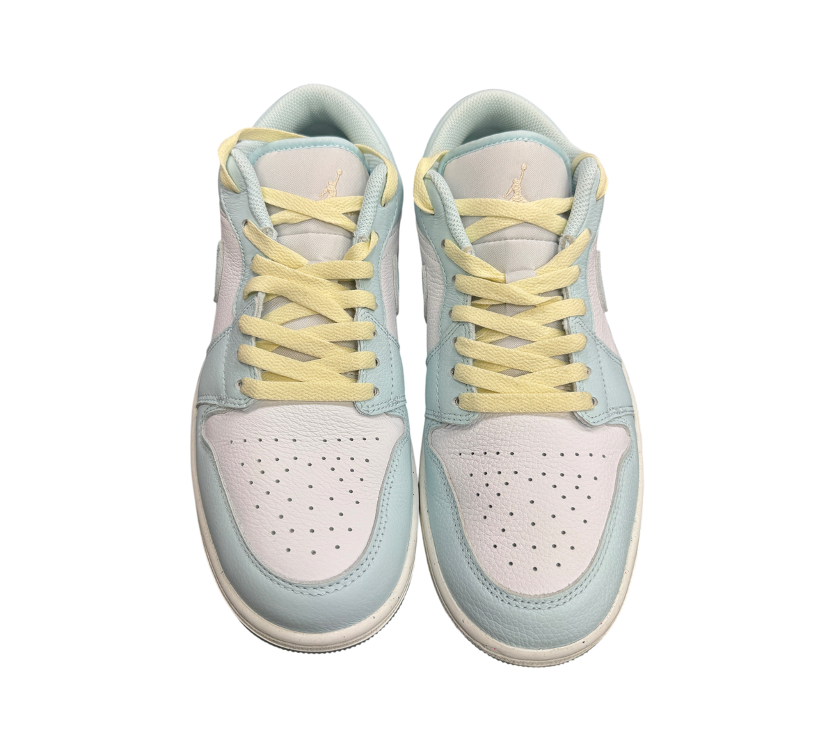 Genesis Boutique Jordan 1 Low Glacier Summit White sneakers featuring pastel blue leather and pale yellow laces.