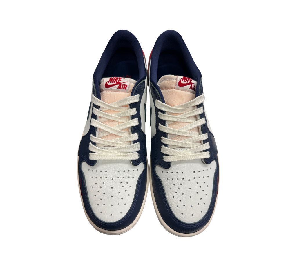 Genesis Boutique Jordan 1 Low Howard Uni sneakers in white, navy blue, and red with white laces and Nike Air branding.