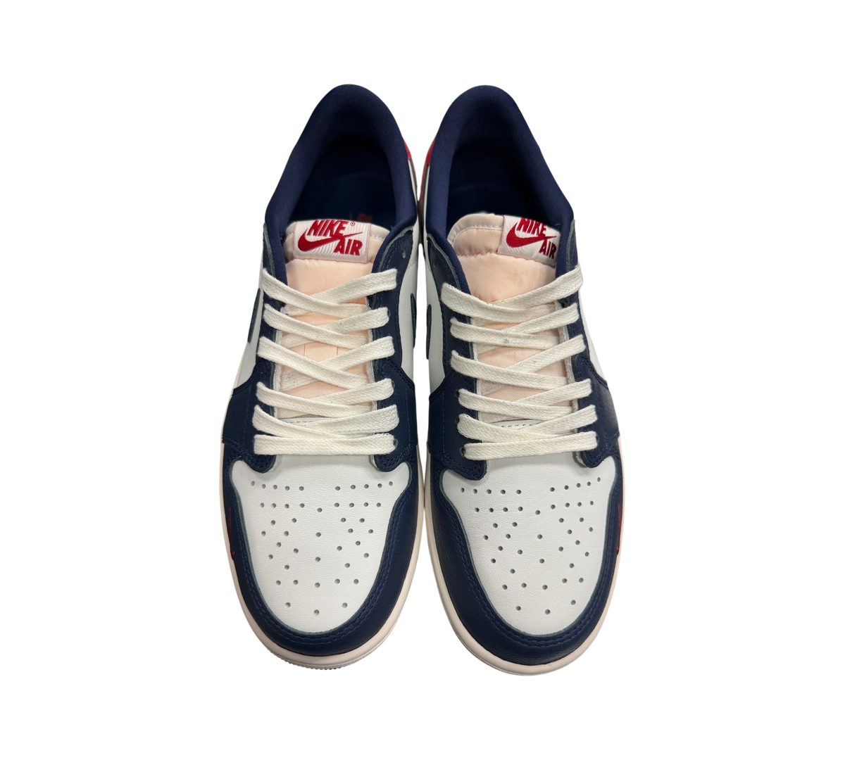 Genesis Boutique Jordan 1 Low Howard Uni sneakers in white, navy blue, and red with white laces and Nike Air branding.