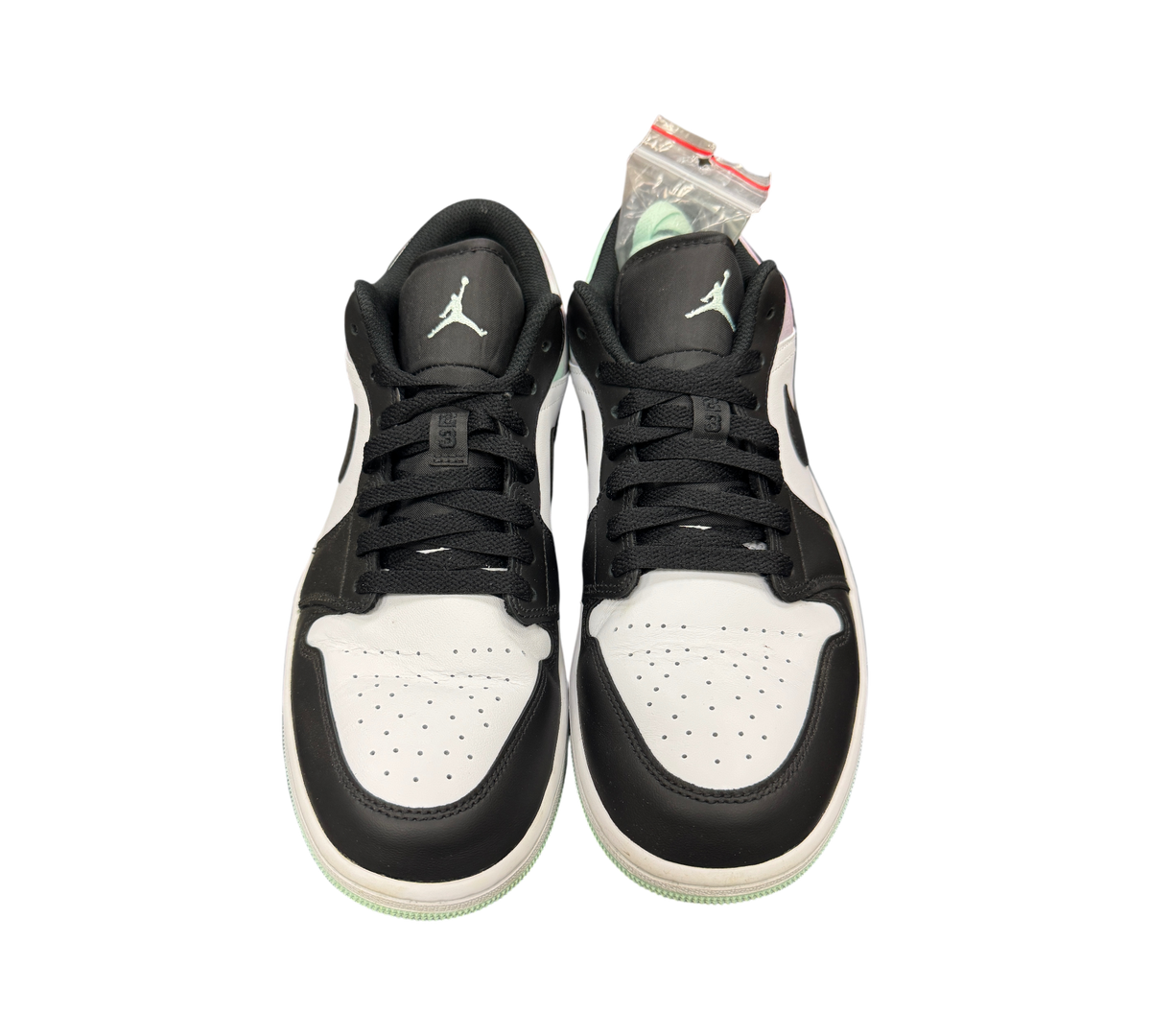 Genesis Boutique Jordan 1 Low Mint Foam sneakers in black, white, and mint green leather with black laces.