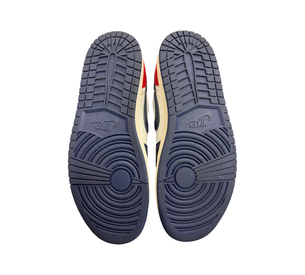 Genesis Boutique Jordan 1 Low Howard Uni sneakers showing the navy blue rubber outsoles with circular tread patterns.