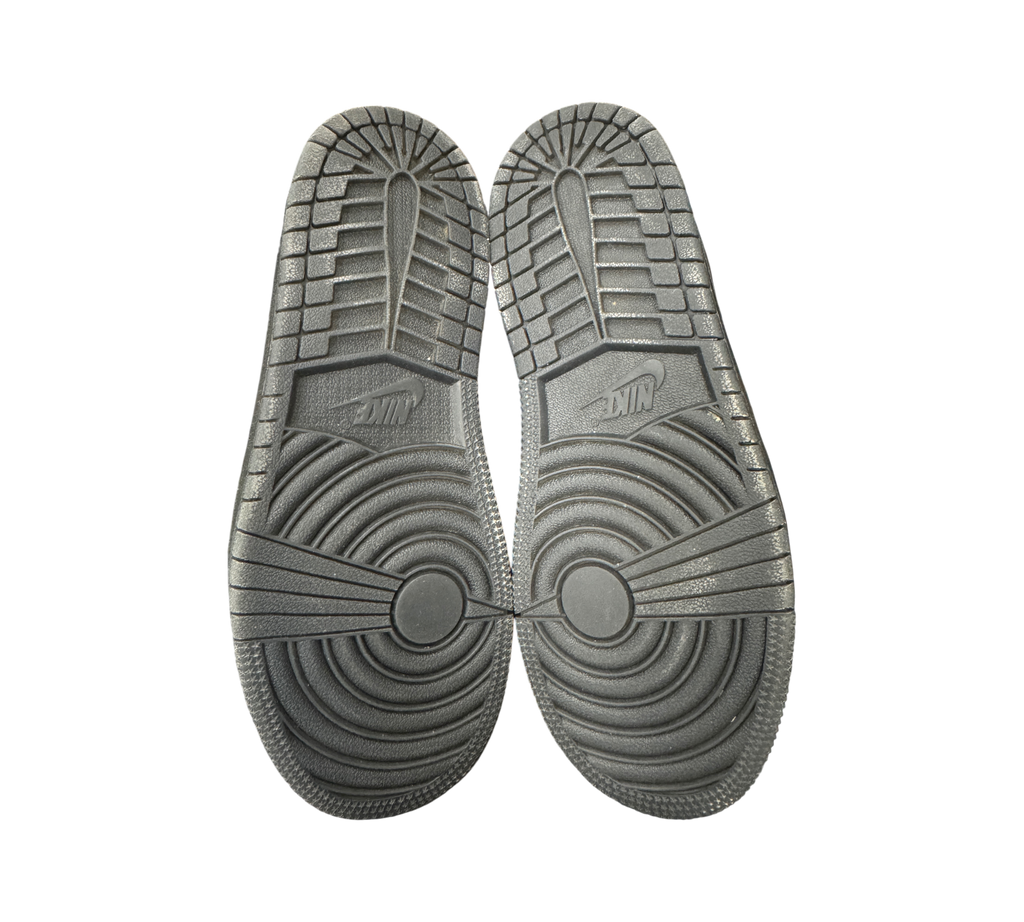 Genesis Boutique Jordan 1 Low Travis Scott Phantom PS sneakers showing black rubber outsoles with Nike branding