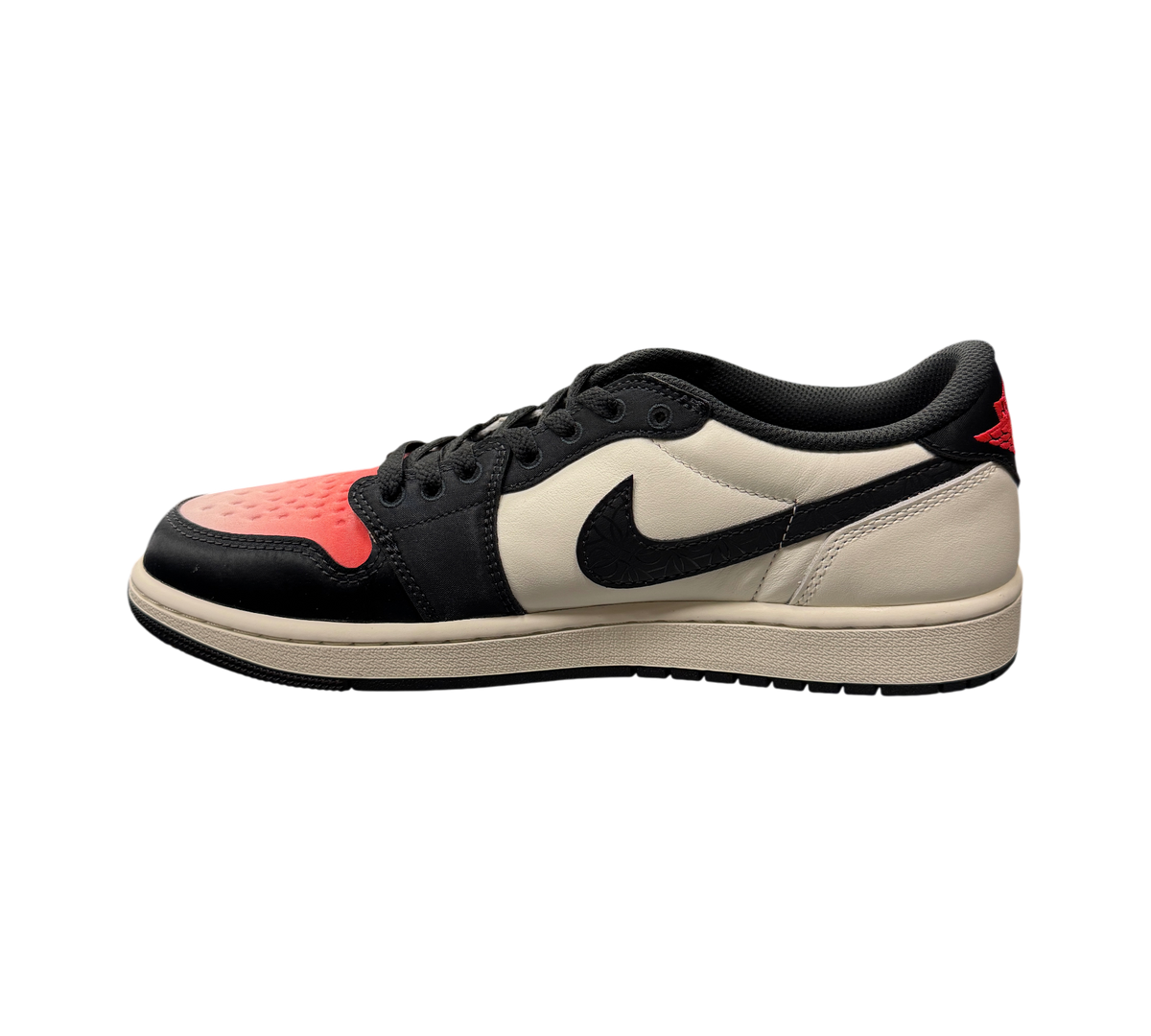 Genesis Boutique Jordan 1 Low PSG sneakers in white, black, and red leather on a glass display case in a retail store.