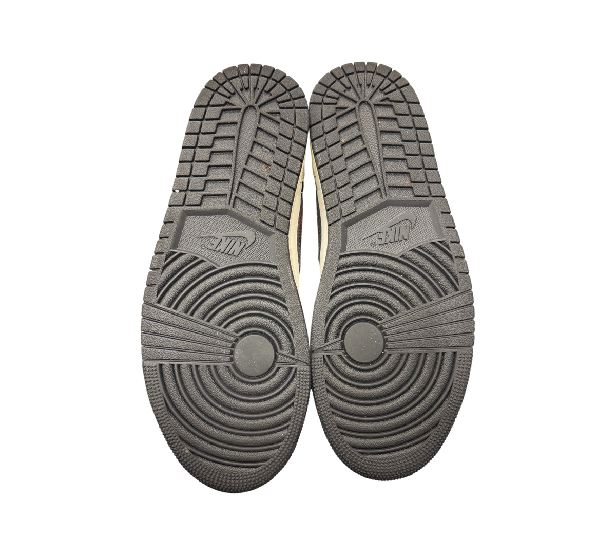 Genesis Boutique Jordan 1 Low PSG sneaker outsoles showing black rubber tread pattern and Nike branding
