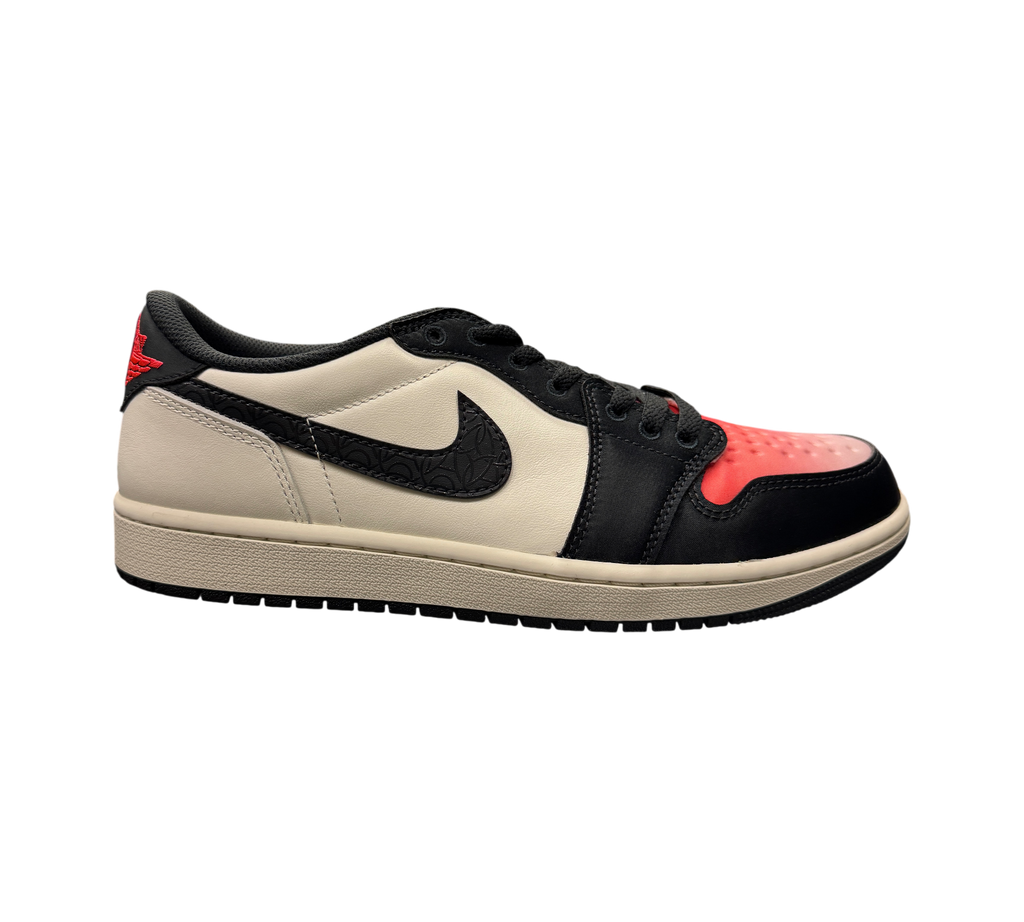 Genesis Boutique Jordan 1 Low PSG sneakers in white, black, and red with patterned swoosh on a glass display counter.