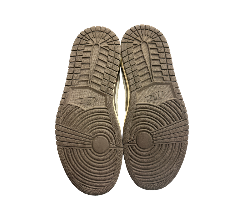 Genesis Boutique Jordan 1 Low Travis Scott Reverse Mocha sneaker outsoles showing minimal wear on brown rubber tread