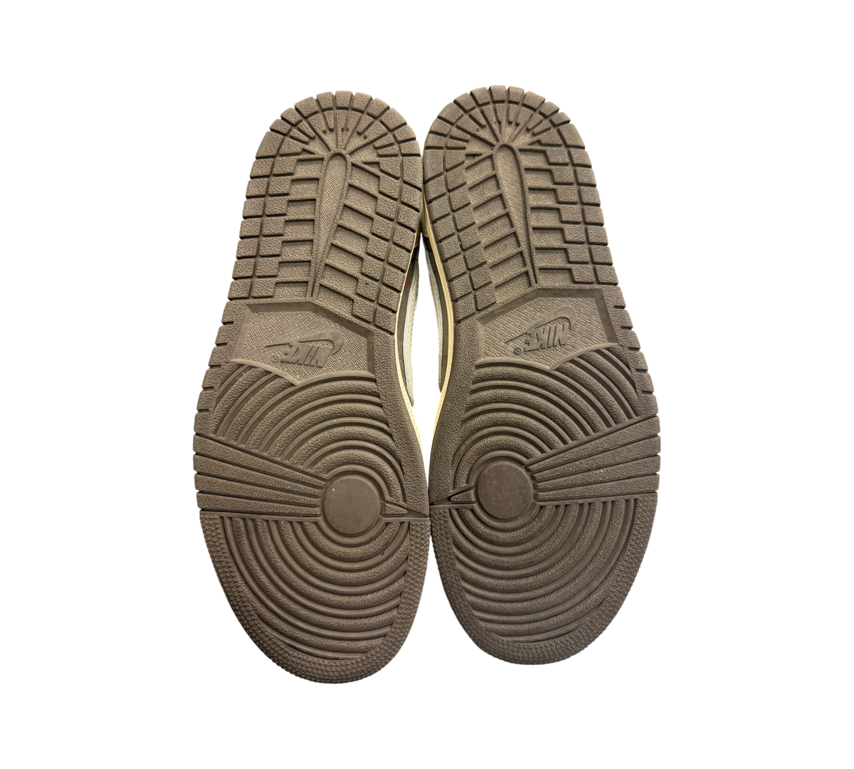 Genesis Boutique Jordan 1 Low Travis Scott Reverse Mocha sneaker outsoles showing minimal wear on brown rubber tread