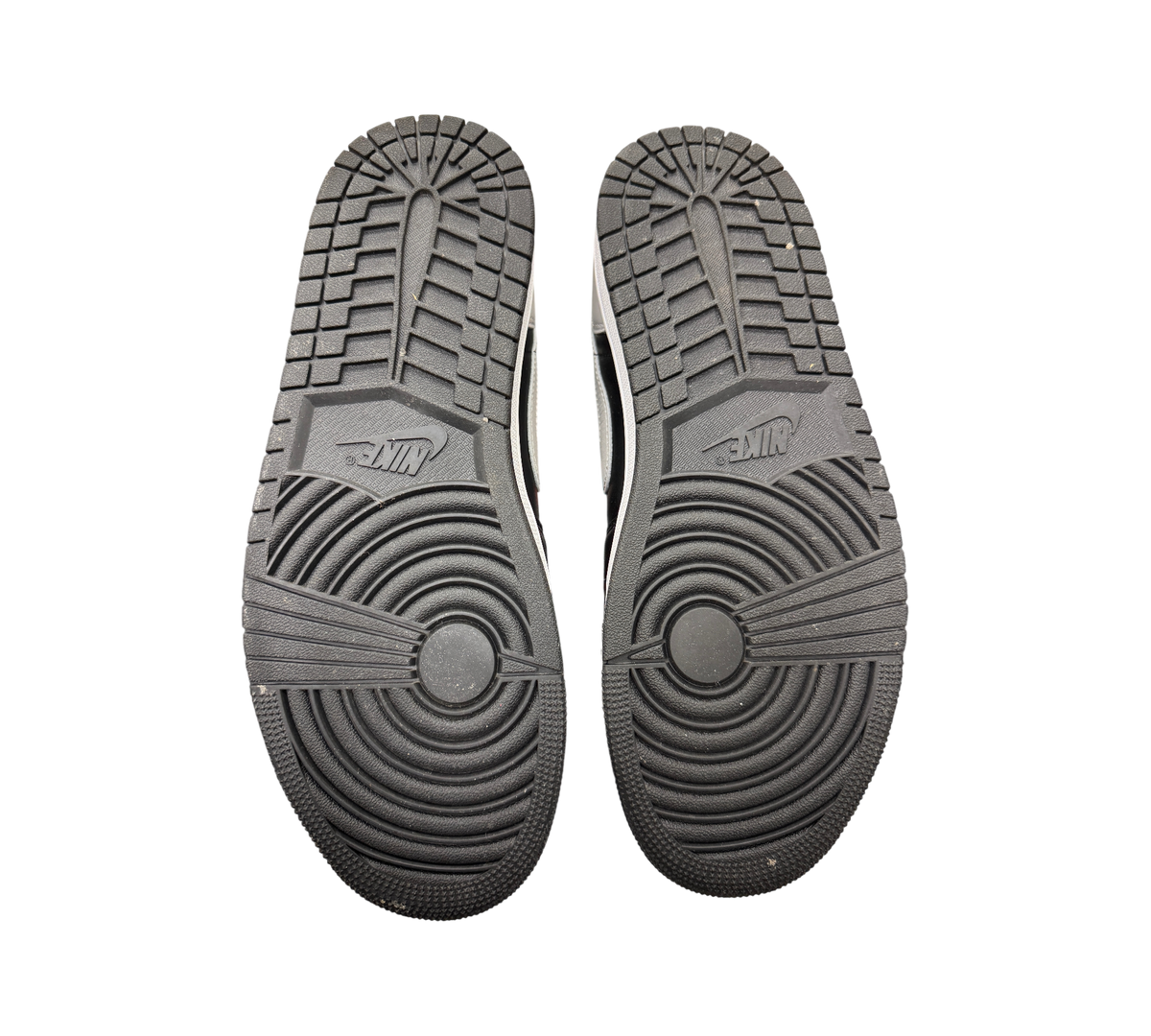 Genesis Boutique used Jordan 1 Low Shadow sneakers showing black rubber outsoles with circular traction patterns.