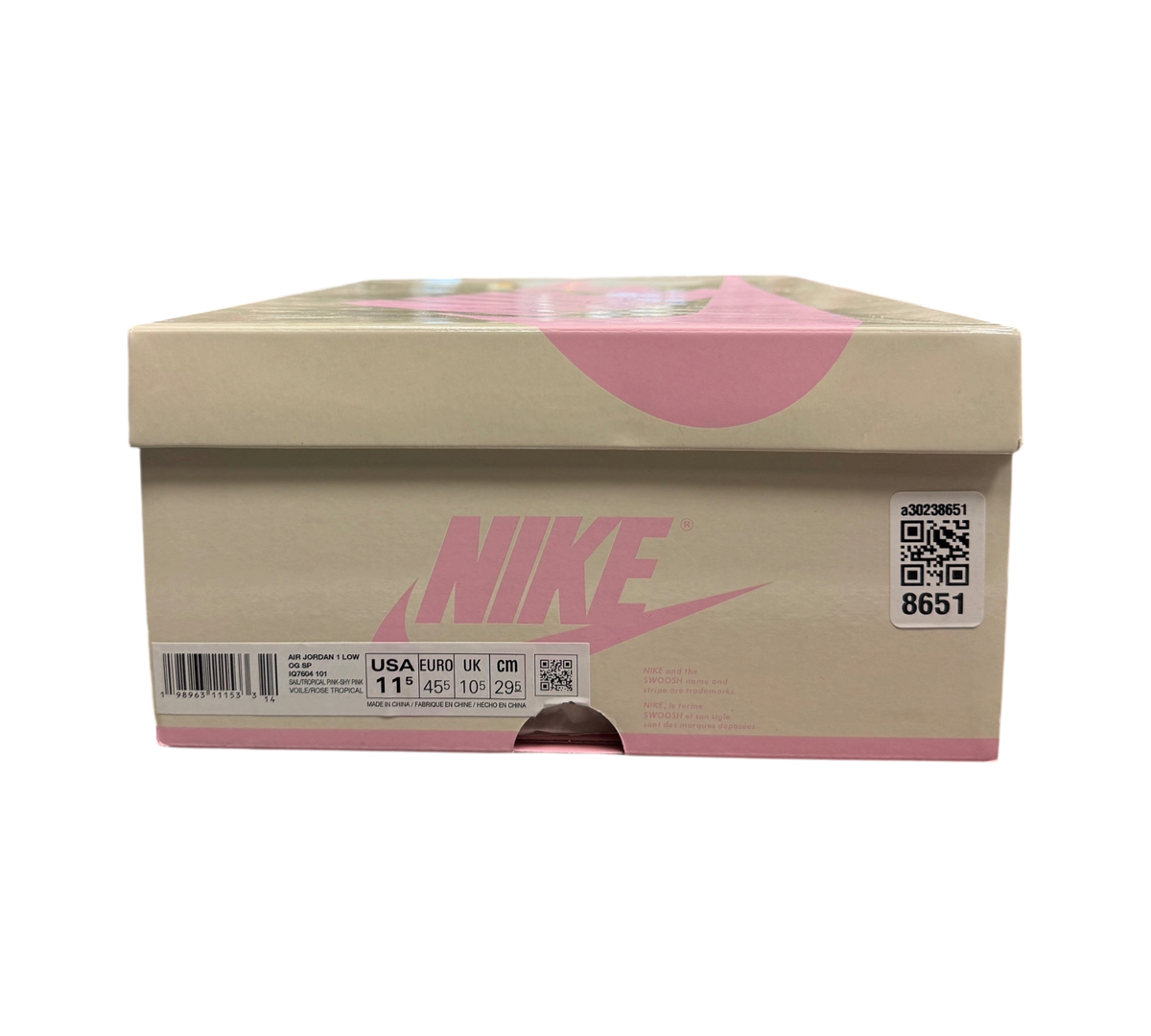 Genesis Boutique Jordan 1 Low Travis Scott Tropical Pink sneaker box with pink Nike branding on a glass display case