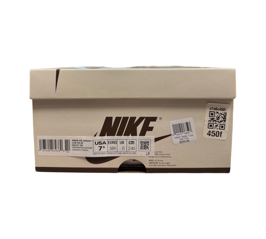 Genesis Boutique Jordan 1 Low Travis Scott Canary sneaker box with product label and size details in a retail store.