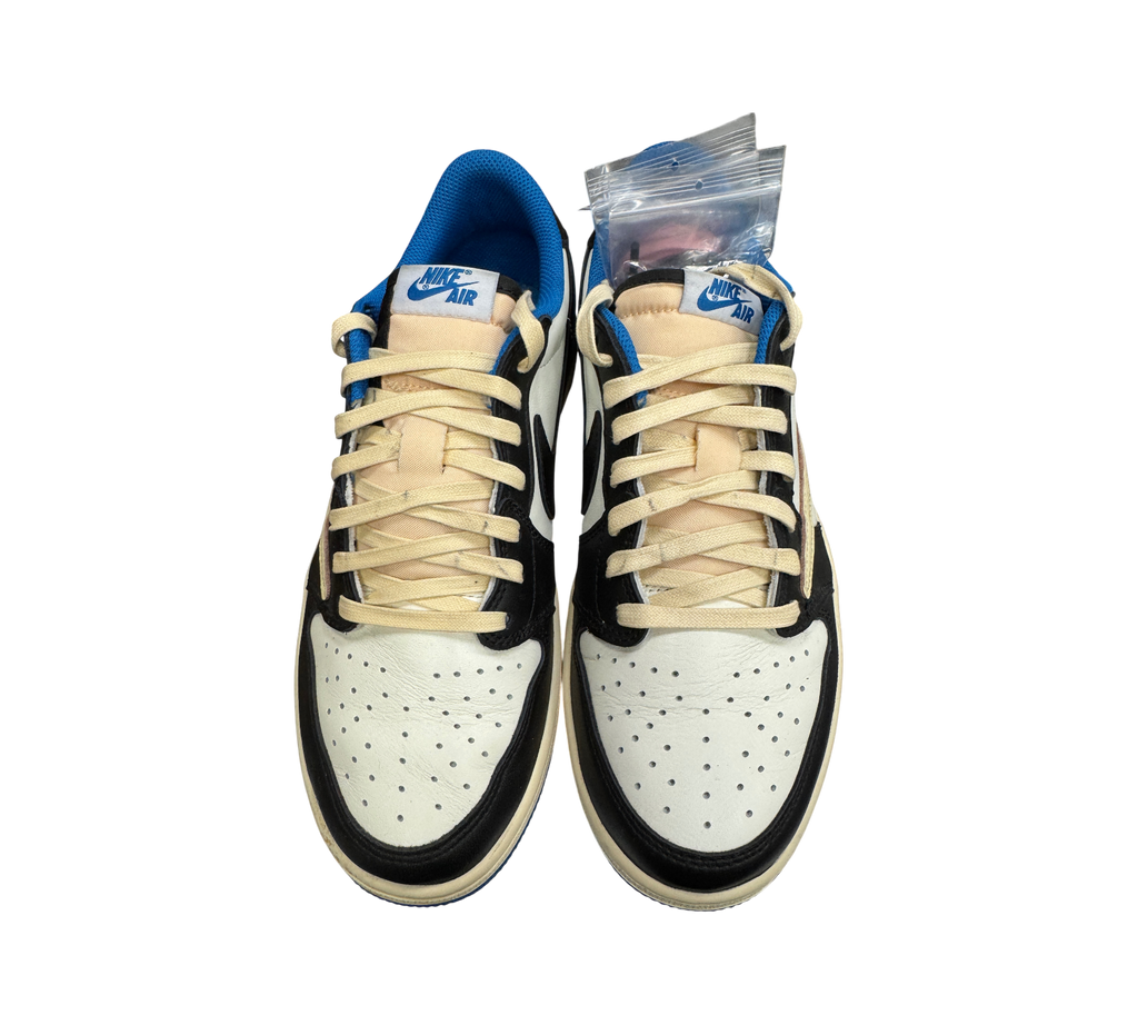 Genesis Boutique Jordan 1 Low Travis Scott Fragment sneakers in white, black, and blue leather with cream laces.