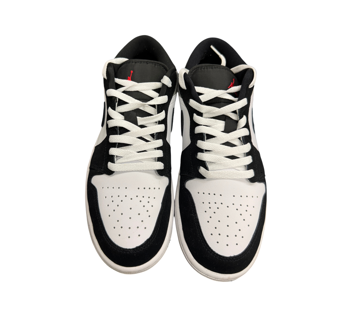 Genesis Boutique Jordan 1 Low sneakers in white, black, and fire red with perforated toe box and lace-up closure.