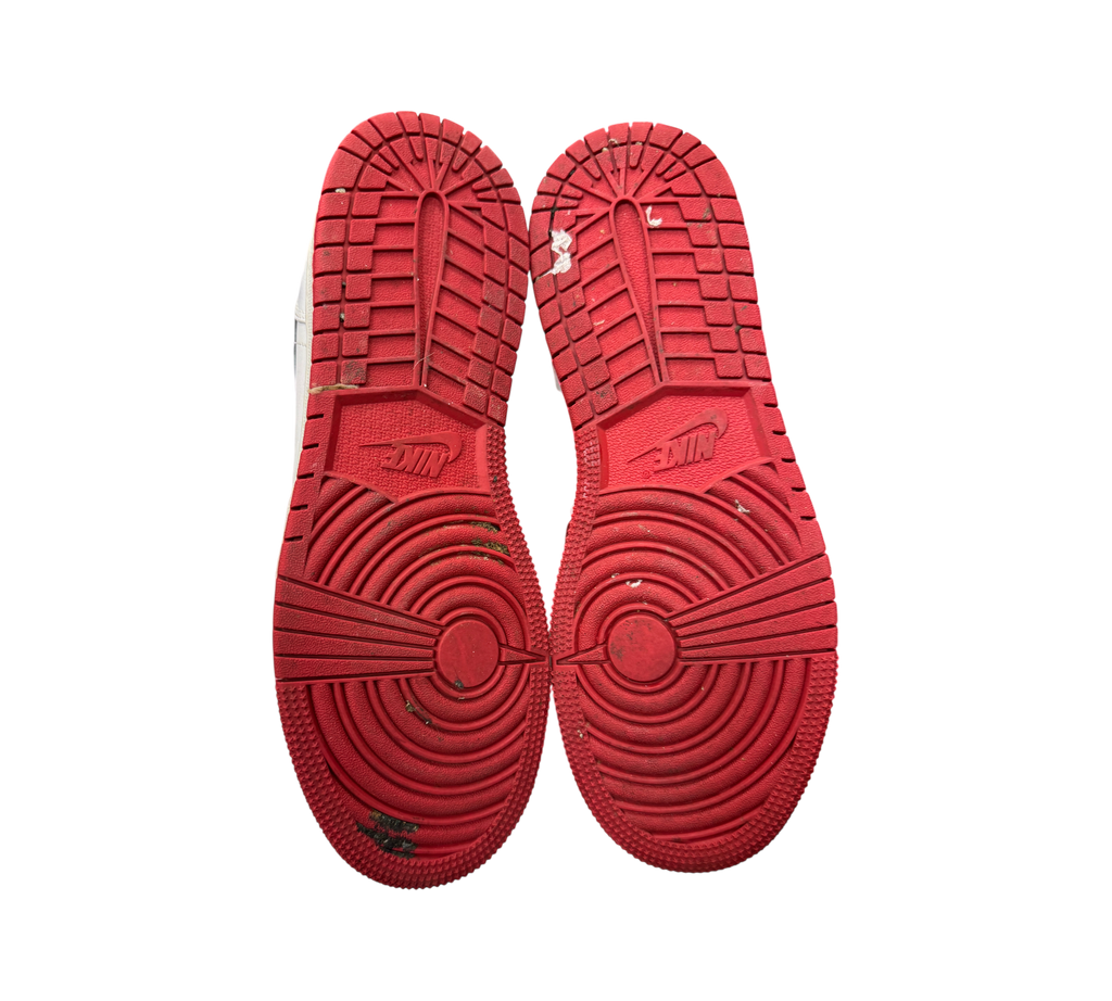 Genesis Boutique used Jordan 1 Mid GS Chicago sneakers showing red rubber outsoles with circular traction patterns