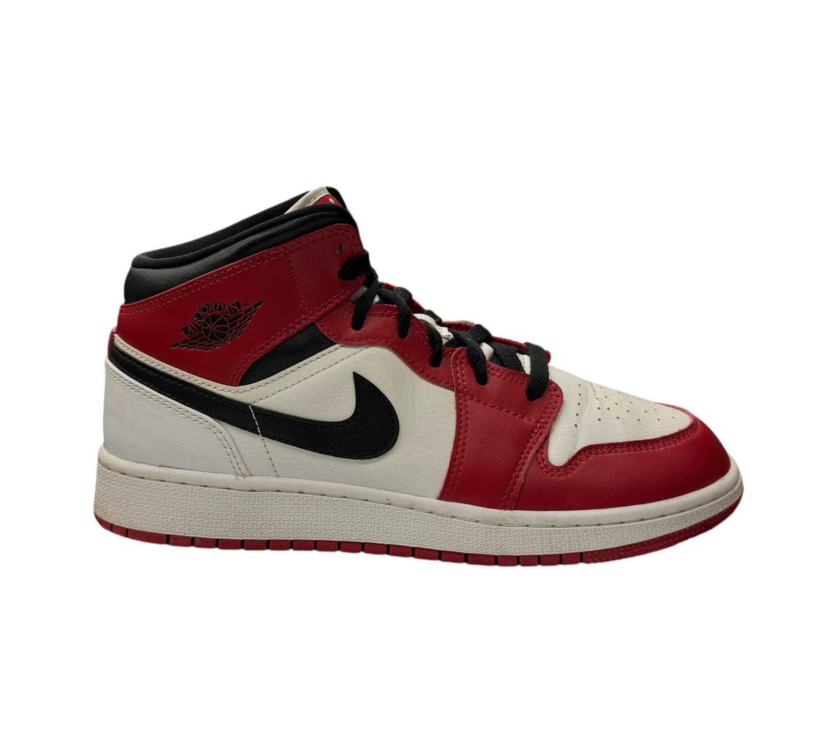 Genesis Boutique Jordan 1 Mid GS Chicago sneakers in red, white, and black leather on display in a retail store.