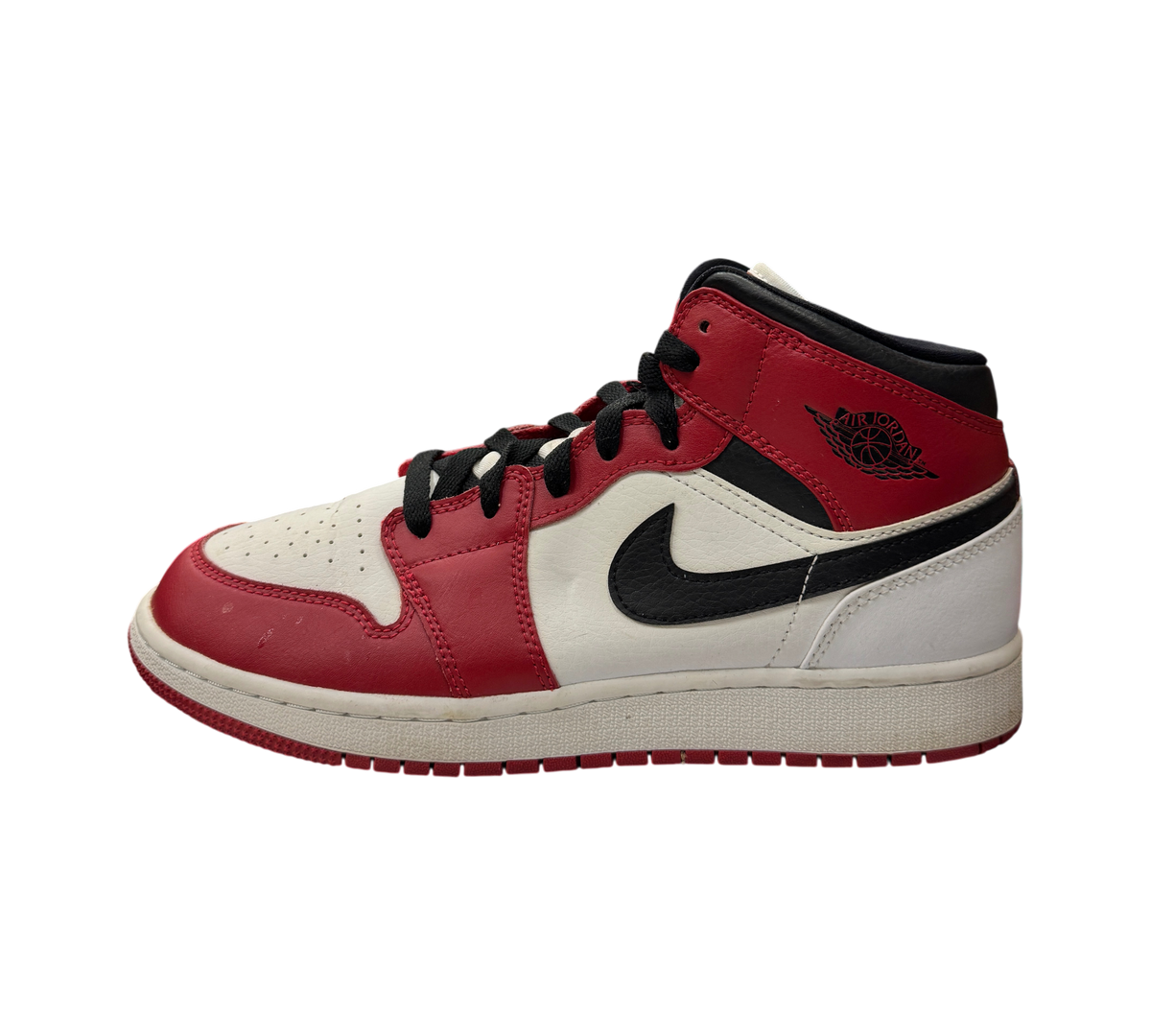 Genesis Boutique Jordan 1 Mid GS Chicago sneakers in white, red, and black leather displayed in a retail store.