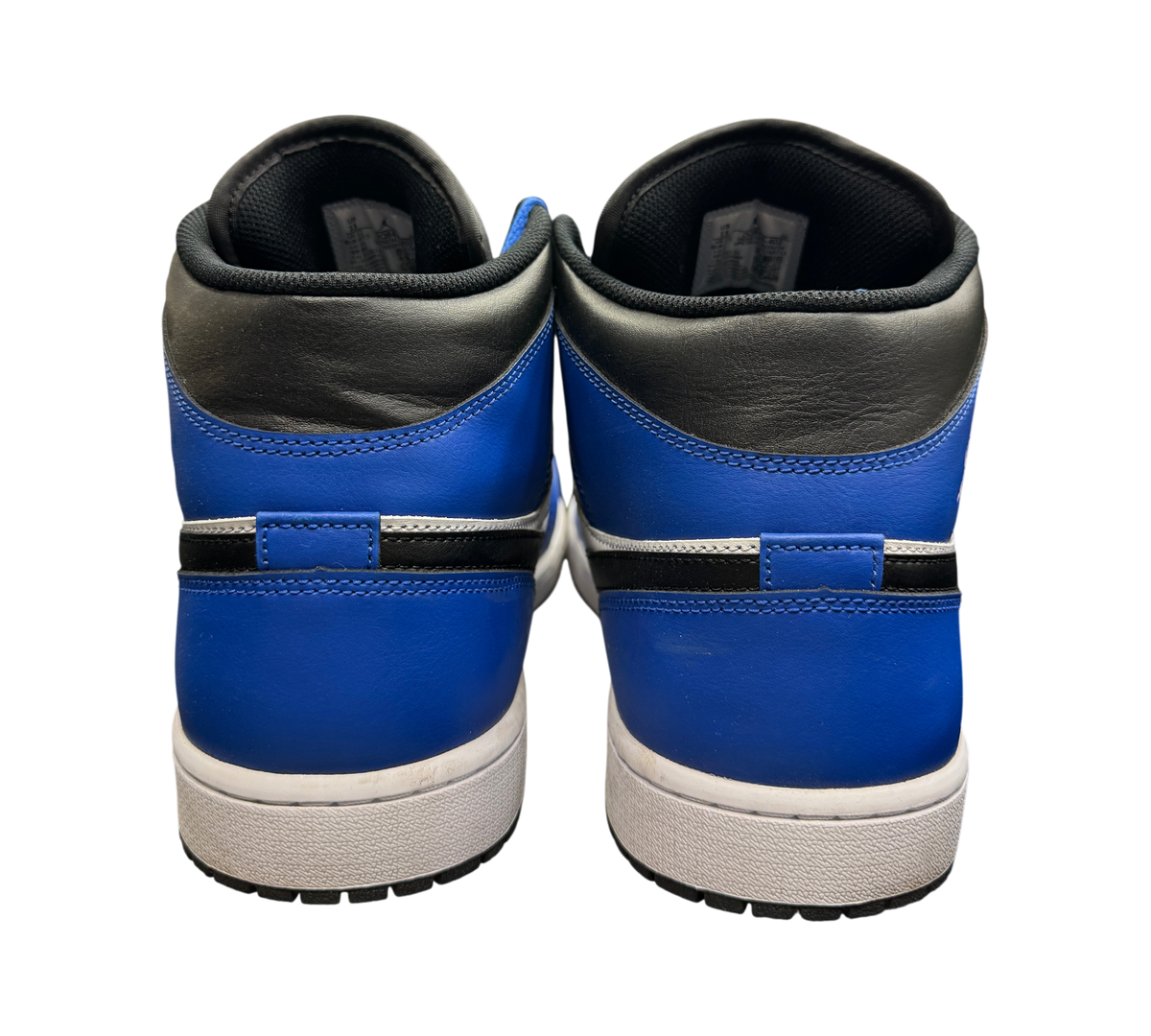 Genesis Boutique Jordan 1 Mid Game Royal sneakers showing the blue and black leather heel and white midsole