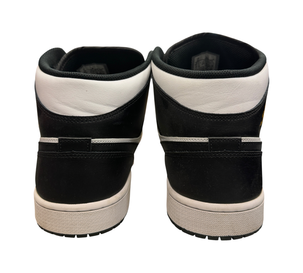 Genesis Boutique Jordan 1 Mid Yellow Ochre sneakers showing the black and white leather heel view