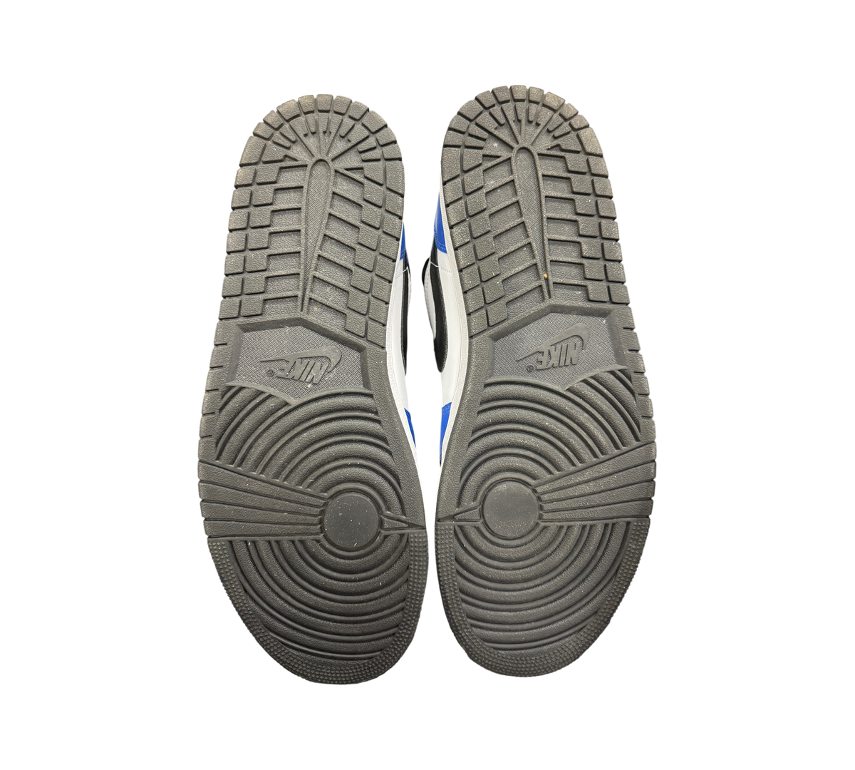 Genesis Boutique used Jordan 1 Mid Game Royal sneakers showing black rubber outsoles with circular traction patterns