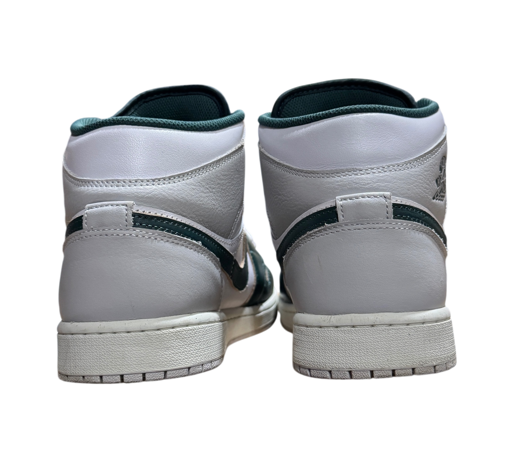 Genesis Boutique Jordan 1 Mid Oxidized Green sneakers showing white leather heels and dark green accents from behind