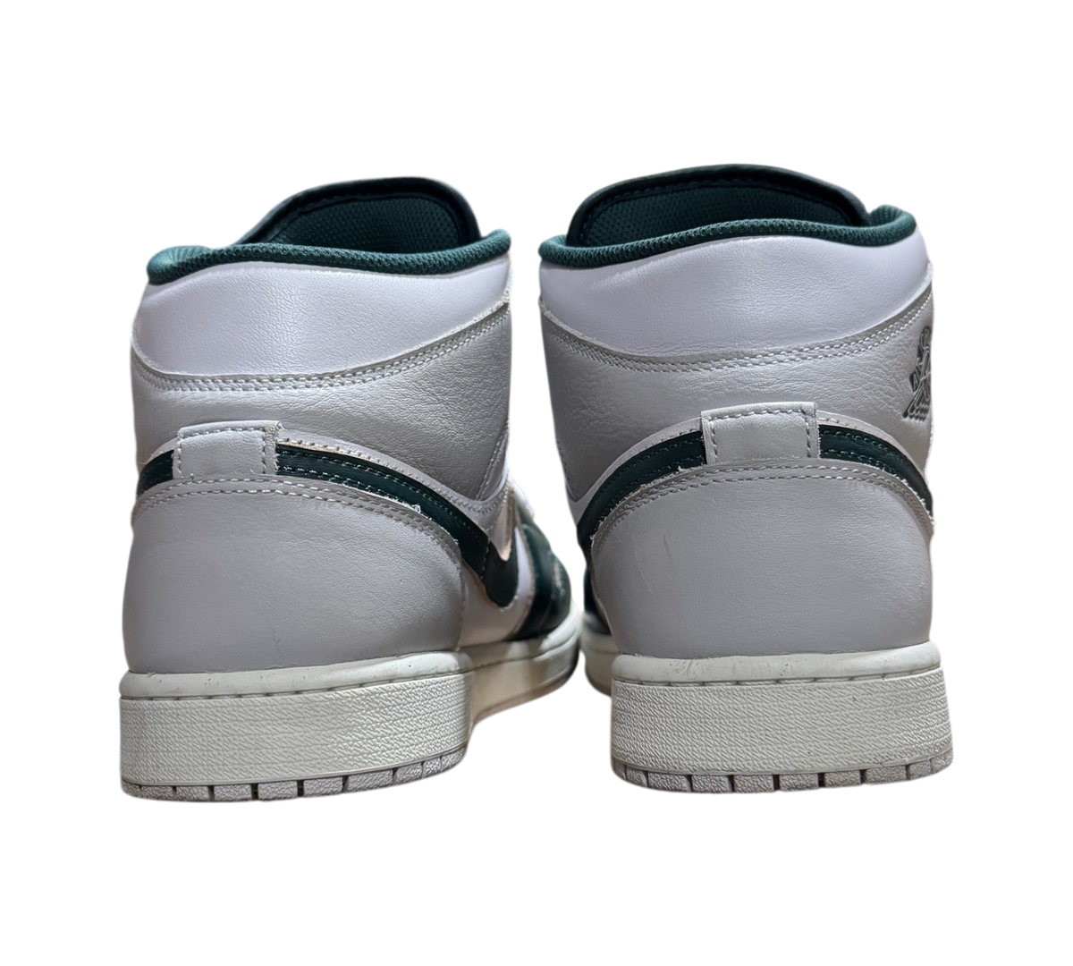 Genesis Boutique Jordan 1 Mid Oxidized Green sneakers showing white leather heels and dark green accents from behind
