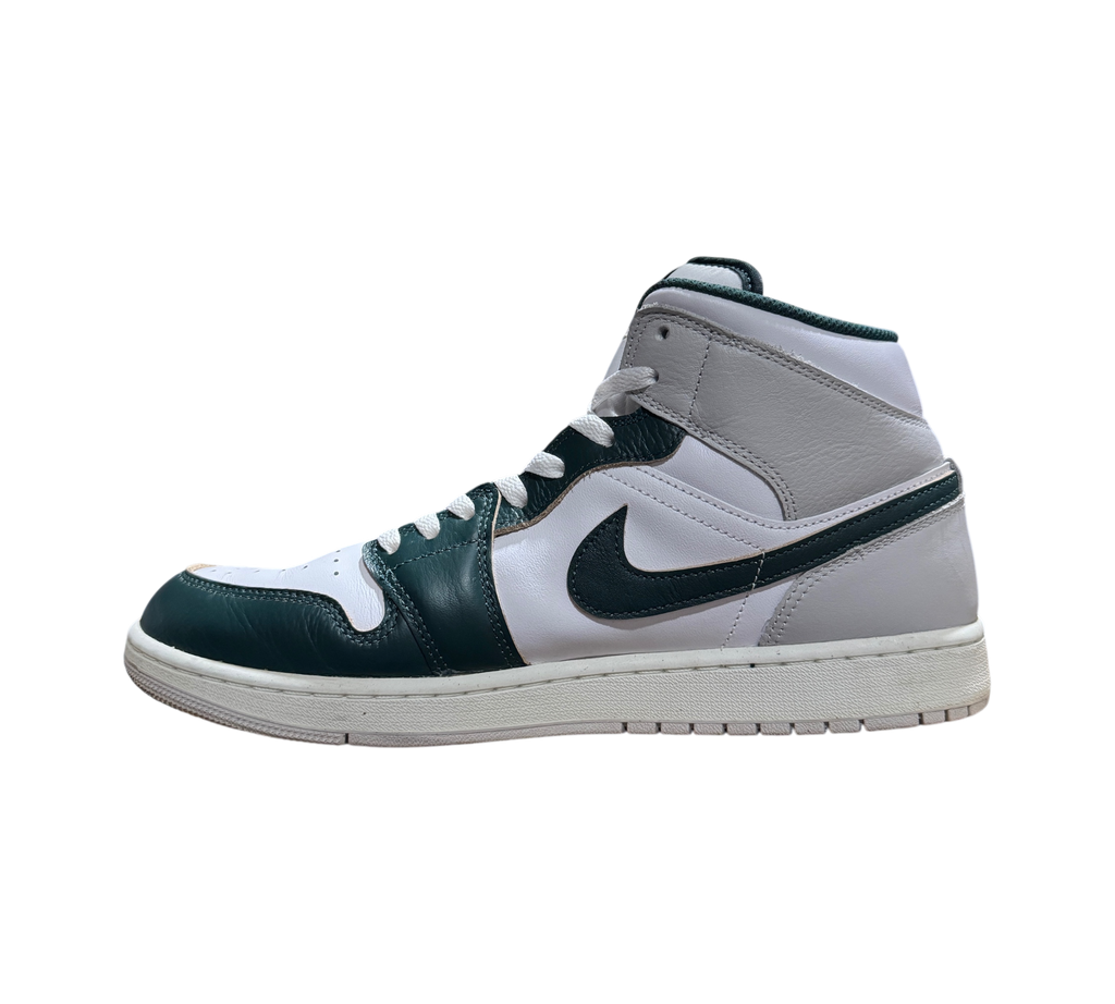 Genesis Boutique Jordan 1 Mid Oxidized Green sneakers featuring white and dark green leather panels in side profile.