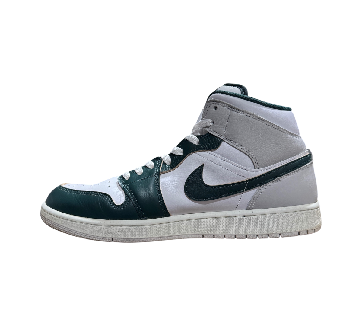 Genesis Boutique Jordan 1 Mid Oxidized Green sneakers featuring white and dark green leather panels in side profile.