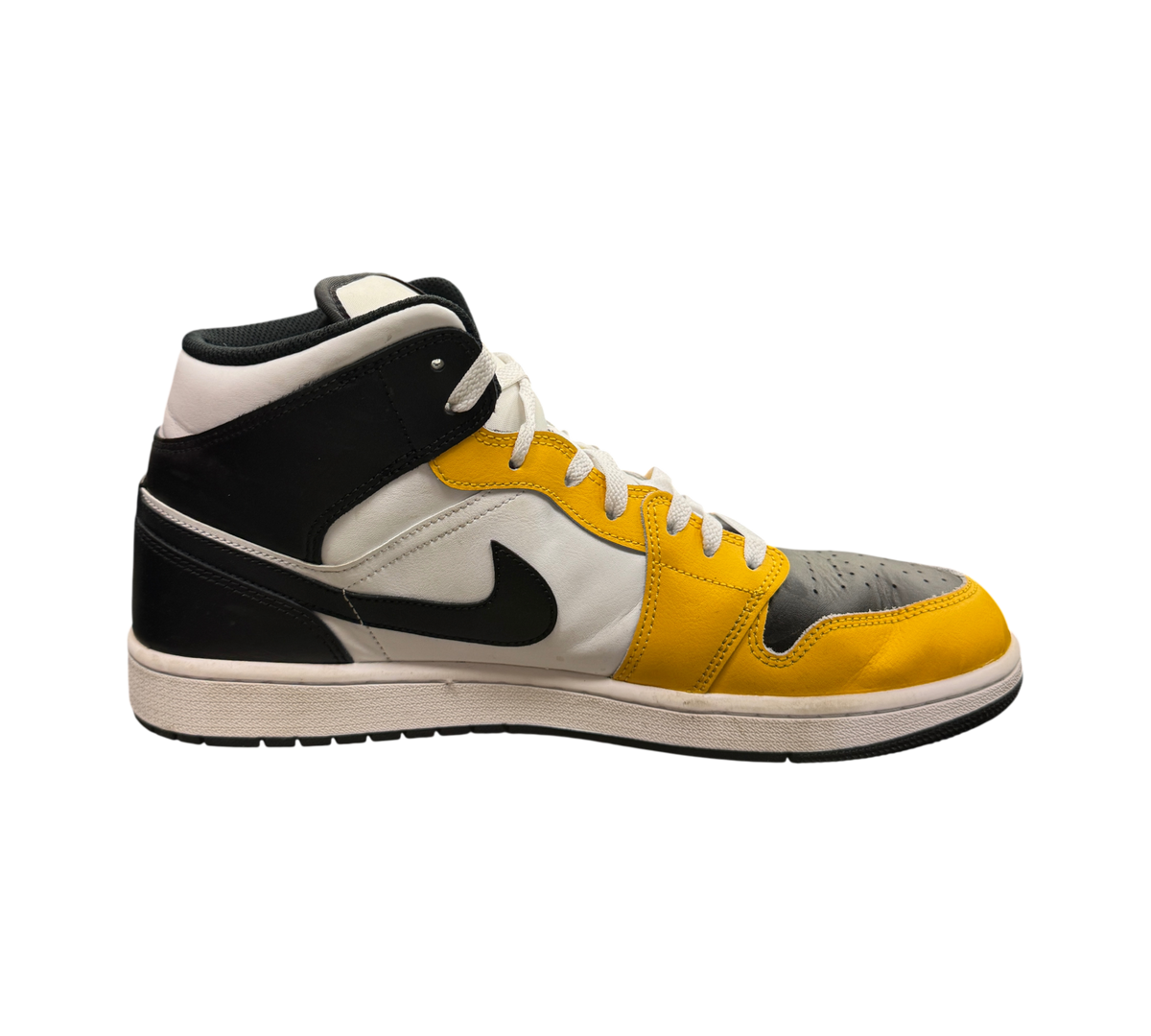 Genesis Boutique Jordan 1 Mid Yellow Ochre sneakers in white, black, and yellow leather with a side profile view.