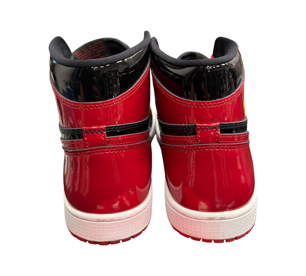 Genesis Boutique Jordan 1 Patent Bred high-top sneakers in glossy red and black patent leather, rear view.