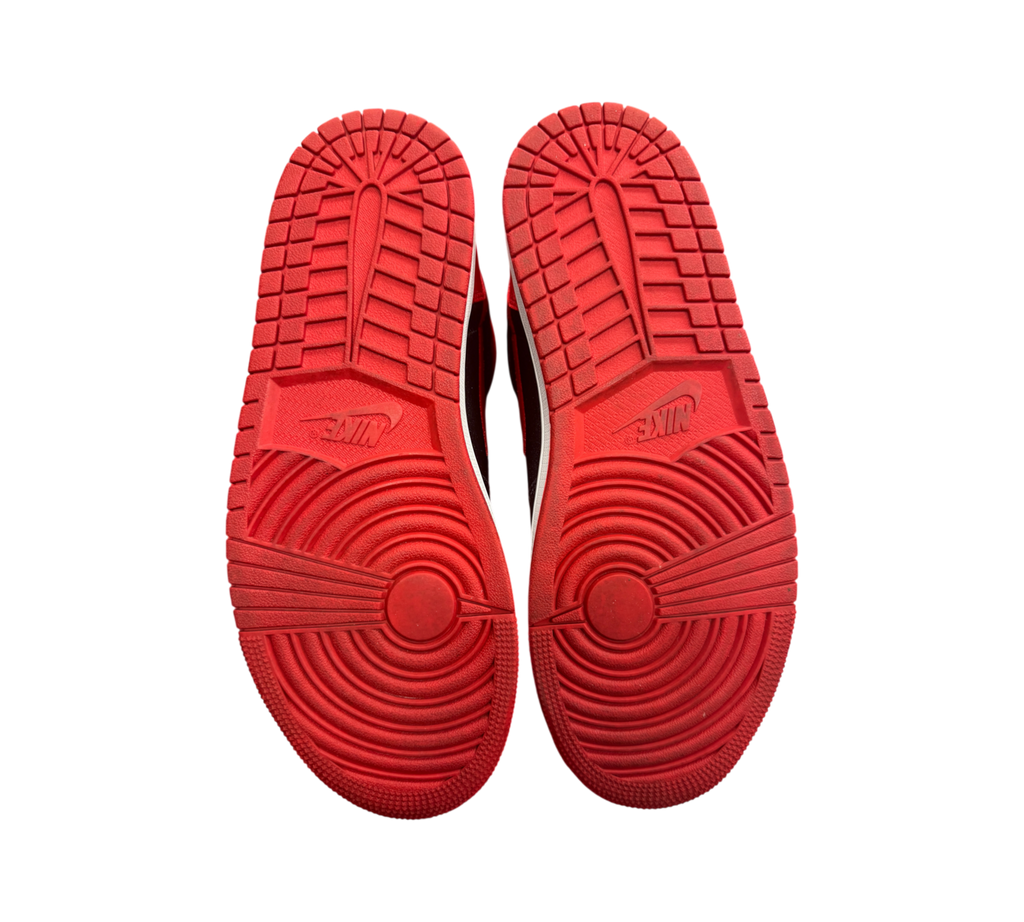 Genesis Boutique Jordan 1 High Satin Bred sneakers showing red rubber outsoles with classic Nike traction pattern
