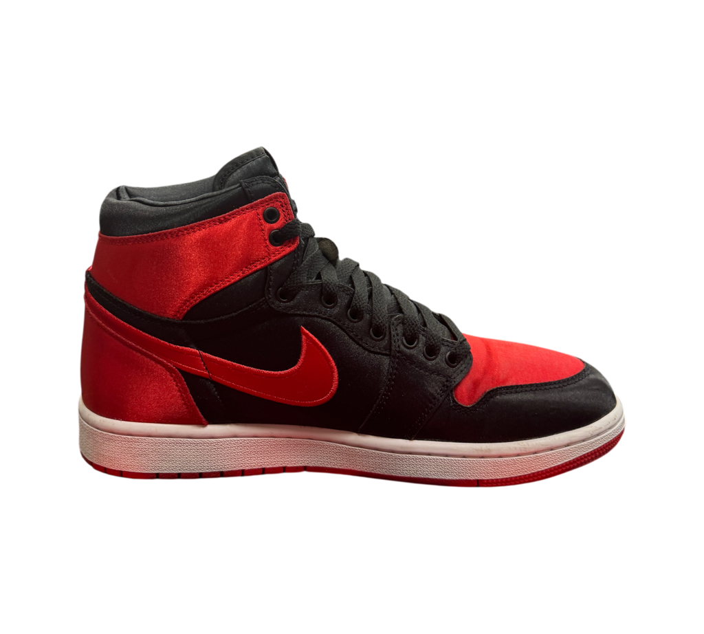 Genesis Boutique Jordan 1 High Satin Bred sneakers in black and red satin with a white midsole and red outsole.