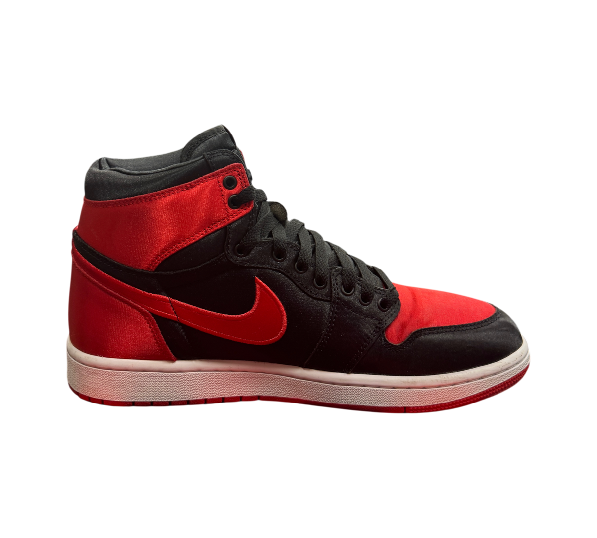 Genesis Boutique Jordan 1 High Satin Bred sneakers in black and red satin with a white midsole and red outsole.