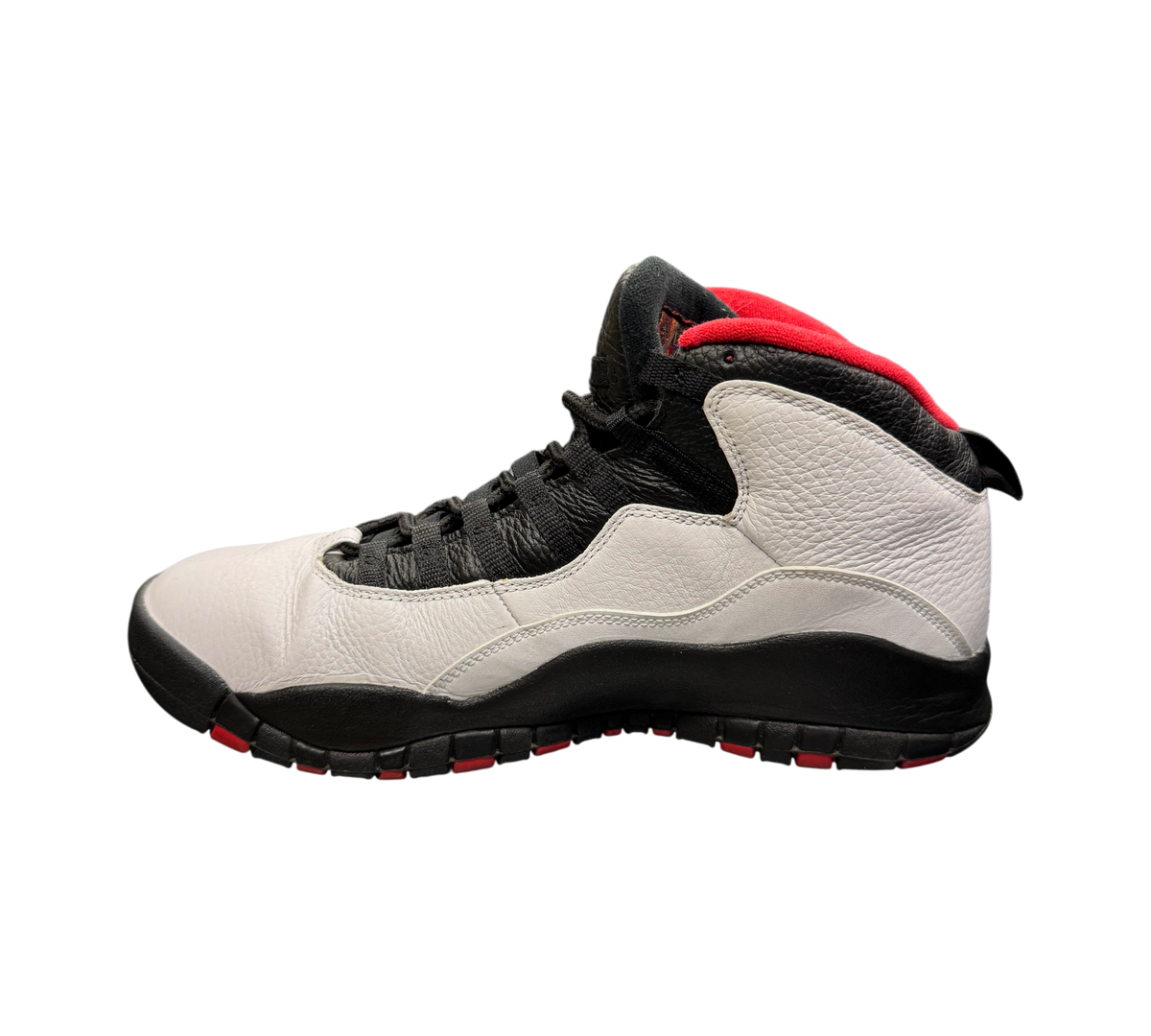 Genesis Boutique Jordan 10 Double Nickel sneakers in white, black, and red leather on a glass display table.