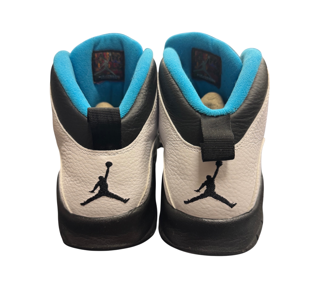 Genesis Boutique Jordan 10 Powder Blue sneakers featuring white leather, black accents, and blue interior lining.