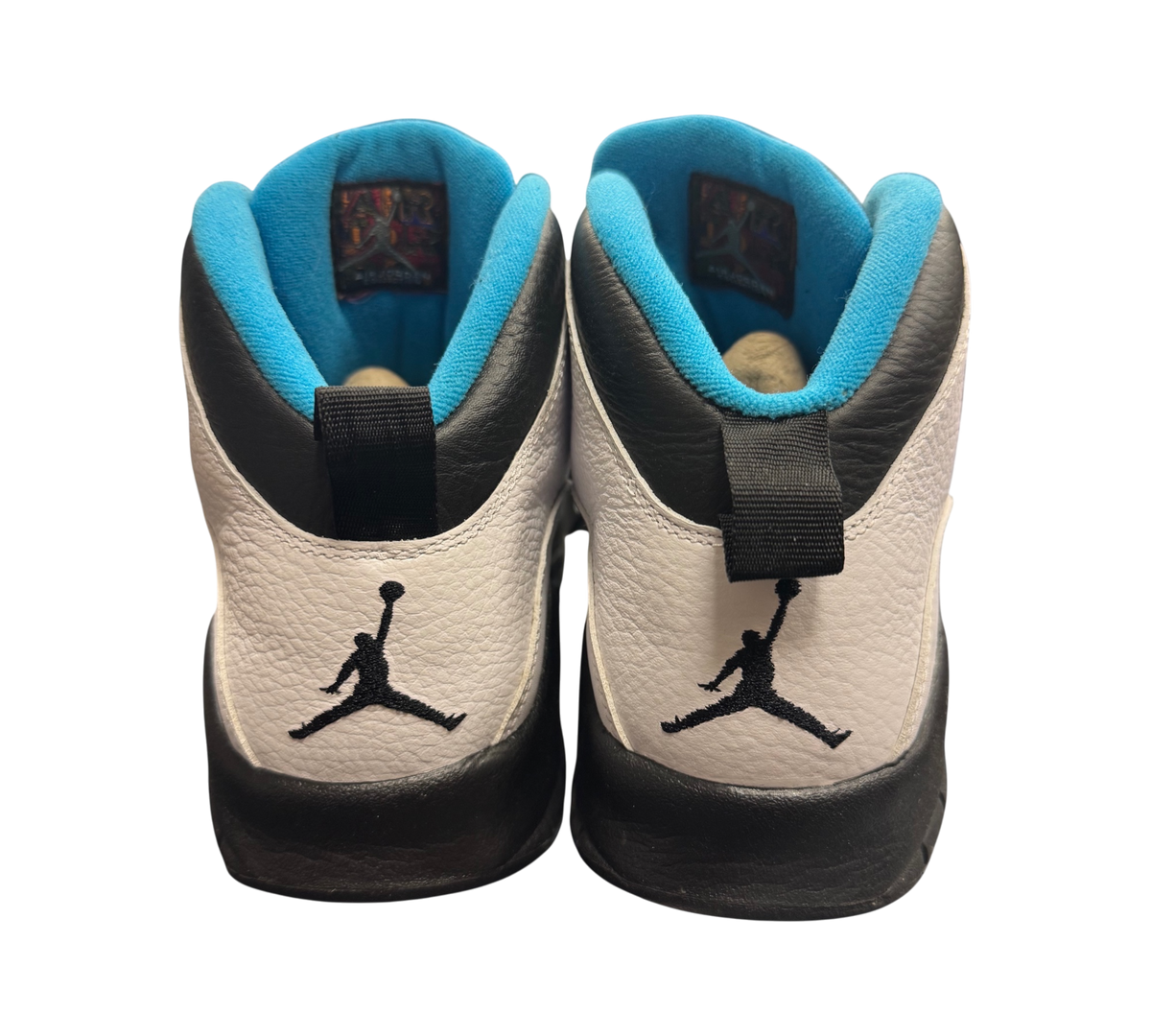 Genesis Boutique Jordan 10 Powder Blue sneakers featuring white leather, black accents, and blue interior lining.
