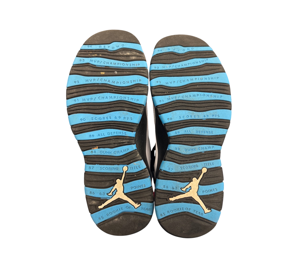 Genesis Boutique Jordan 10 Powder Blue sneaker outsoles featuring career achievement text and Jumpman logo